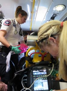 Paramedic with monitor in the back of an ambulance